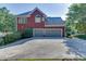 Two-story brick home with a large two car garage and driveway at 1777 Water Springs Way, Dacula, GA 30019