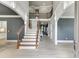 Spacious foyer with high ceilings, wood staircase, and views of the open-concept layout at 1777 Water Springs Way, Dacula, GA 30019
