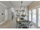 Eat-in kitchen with white cabinets, stainless appliances, island, and backyard view at 1777 Water Springs Way, Dacula, GA 30019