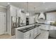 Stylish kitchen with black countertops, white cabinets, a large island, and stainless steel appliances for a modern look at 1777 Water Springs Way, Dacula, GA 30019