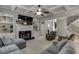 Open-concept living room with coffered ceilings, fireplace, and seamless flow to kitchen and staircase at 1777 Water Springs Way, Dacula, GA 30019