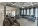 Open living room with a large sofa and view to the kitchen and backyard at 1777 Water Springs Way, Dacula, GA 30019