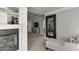 Inviting main bedroom with fireplace, lounge chair, and dark framed mirror at 1777 Water Springs Way, Dacula, GA 30019