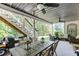 Covered patio with a dining table, seating area, and stairs to backyard at 1777 Water Springs Way, Dacula, GA 30019