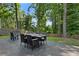 Outdoor back deck with a dining table, chairs, and lush green trees offering a relaxing outdoor space at 2416 Elmwood Se Cir, Atlanta, GA 30339