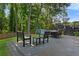 Spacious wooden deck with a bench, table, and a charming blue shed in a lush backyard setting at 2416 Elmwood Se Cir, Atlanta, GA 30339