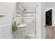 Bathroom with subway tile walls, glass shower doors, modern vanity, and hexagon tile flooring at 2416 Elmwood Se Cir, Atlanta, GA 30339