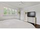 Bright bedroom featuring white walls, plantation shutters, and neutral-toned furnishings at 2416 Elmwood Se Cir, Atlanta, GA 30339