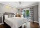 Bedroom with elegant trim work, access to deck, and stylish patterned curtains at 2416 Elmwood Se Cir, Atlanta, GA 30339