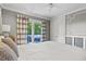 Bedroom with elegant trim work, access to deck, and stylish patterned curtains at 2416 Elmwood Se Cir, Atlanta, GA 30339