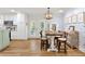 Open dining area with chandelier, wood table and view into the kitchen at 2416 Elmwood Se Cir, Atlanta, GA 30339