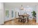 Open dining area with chandelier, wood table and view into the backyard at 2416 Elmwood Se Cir, Atlanta, GA 30339