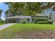 Beautifully landscaped front yard with a brick house and covered side entrance at 2416 Elmwood Se Cir, Atlanta, GA 30339