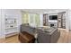 Bright living room with a cozy sectional, built-in shelving, and stylish decor at 2416 Elmwood Se Cir, Atlanta, GA 30339