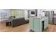 Open living area with kitchen island, gray sectional sofa, and built-in shelving at 2416 Elmwood Se Cir, Atlanta, GA 30339