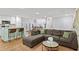Open living area with kitchen island, gray sectional sofa, and dining room at 2416 Elmwood Se Cir, Atlanta, GA 30339
