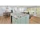 Open living area with kitchen island, gray sectional sofa, and dining room at 2416 Elmwood Se Cir, Atlanta, GA 30339