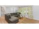 Comfortable living room with a sectional sofa, natural light, and stylish decor at 2416 Elmwood Se Cir, Atlanta, GA 30339