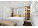 Bedroom with built-in bookshelves, recessed lighting, and shuttered windows at 2416 Elmwood Se Cir, Atlanta, GA 30339
