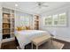 Spacious bedroom with built-in bookshelves, recessed lighting, and shuttered windows at 2416 Elmwood Se Cir, Atlanta, GA 30339