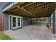 Covered outdoor patio area with double doors, offering a versatile space for entertaining at 2416 Elmwood Se Cir, Atlanta, GA 30339