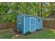 Charming shed with a blue exterior and ample storage space, surrounded by lush greenery at 2416 Elmwood Se Cir, Atlanta, GA 30339