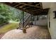 Exterior view showing a deck with stairs leading to a gravel patio, creating an inviting outdoor space at 3710 Ridgefair Dr, Cumming, GA 30040