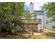 Back exterior showing a deck with stairs leading to the yard, complemented by mature trees and landscaping at 3710 Ridgefair Dr, Cumming, GA 30040