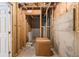 Basement utility area with exposed framing, concrete walls, and a water heater, offering potential for storage at 3710 Ridgefair Dr, Cumming, GA 30040