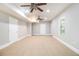 Finished basement with carpeted flooring, multiple ceiling fans, and natural light at 3710 Ridgefair Dr, Cumming, GA 30040