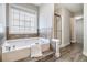 Bathroom featuring soaking tub with tile surround and separate shower at 3710 Ridgefair Dr, Cumming, GA 30040