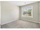 Bedroom with carpeted floors and window with backyard view at 3710 Ridgefair Dr, Cumming, GA 30040
