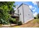 Rear exterior view showcasing a deck, neutral siding, chimney, and easy access to backyard at 3710 Ridgefair Dr, Cumming, GA 30040