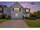 Charming two-story home with a well-maintained lawn and a two-car garage at dusk at 3710 Ridgefair Dr, Cumming, GA 30040