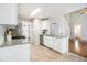 Kitchen boasts tile flooring, granite counters, and white cabinets, with an eat-in dining area at 3710 Ridgefair Dr, Cumming, GA 30040
