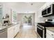 Modern kitchen with stainless steel appliances, granite countertops, and tile flooring at 3710 Ridgefair Dr, Cumming, GA 30040