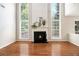 Living room features hardwood floors, fireplace, and large windows with natural light at 3710 Ridgefair Dr, Cumming, GA 30040