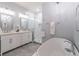 Luxurious bathroom featuring dual sinks, stylish vanity, soaking tub and glass enclosed shower at 510 Independence Way, Roswell, GA 30075