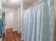This bathroom features a shower with blue patterned curtain and wood-look floors at 510 Independence Way, Roswell, GA 30075