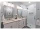 Elegant bathroom featuring dual sinks, stylish vanity, glass enclosed shower and tile floor at 510 Independence Way, Roswell, GA 30075