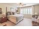Spacious bedroom featuring natural light, neutral carpet, ceiling fan and a sitting area at 510 Independence Way, Roswell, GA 30075