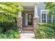 Inviting front door with stone accents, sidelights and decorative glass provides a warm welcome at 510 Independence Way, Roswell, GA 30075