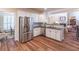Well-equipped kitchen with stainless steel appliances, granite countertops and hardwood floors open to the living area at 510 Independence Way, Roswell, GA 30075