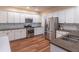 Charming kitchen featuring granite countertops, stainless steel appliances, and stylish backsplash and wood floors at 510 Independence Way, Roswell, GA 30075