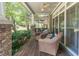 Relaxing porch with comfortable seating, ceiling fan and stone pillars creating an inviting outdoor space at 510 Independence Way, Roswell, GA 30075