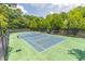 Outdoor tennis court surrounded by lush greenery at 510 Independence Way, Roswell, GA 30075