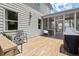 View of the back deck with outdoor seating and a screened-in porch area, enhancing outdoor living at 5605 Miners Rdg, Cumming, GA 30028