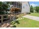 View of the home exterior and wooden fence bordering the grassy backyard at 5605 Miners Rdg, Cumming, GA 30028