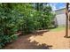 A view of a fenced backyard with mature trees and landscaping at 5605 Miners Rdg, Cumming, GA 30028