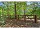 Backyard with a natural wooden fence and lush green trees providing privacy at 5605 Miners Rdg, Cumming, GA 30028